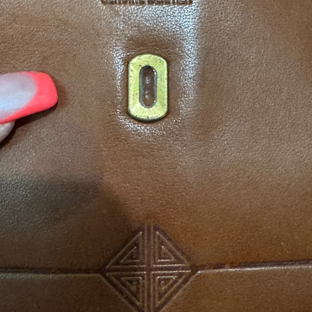 Vintage Brown Leather Wallet with Snap Closure and Embossed Emblem